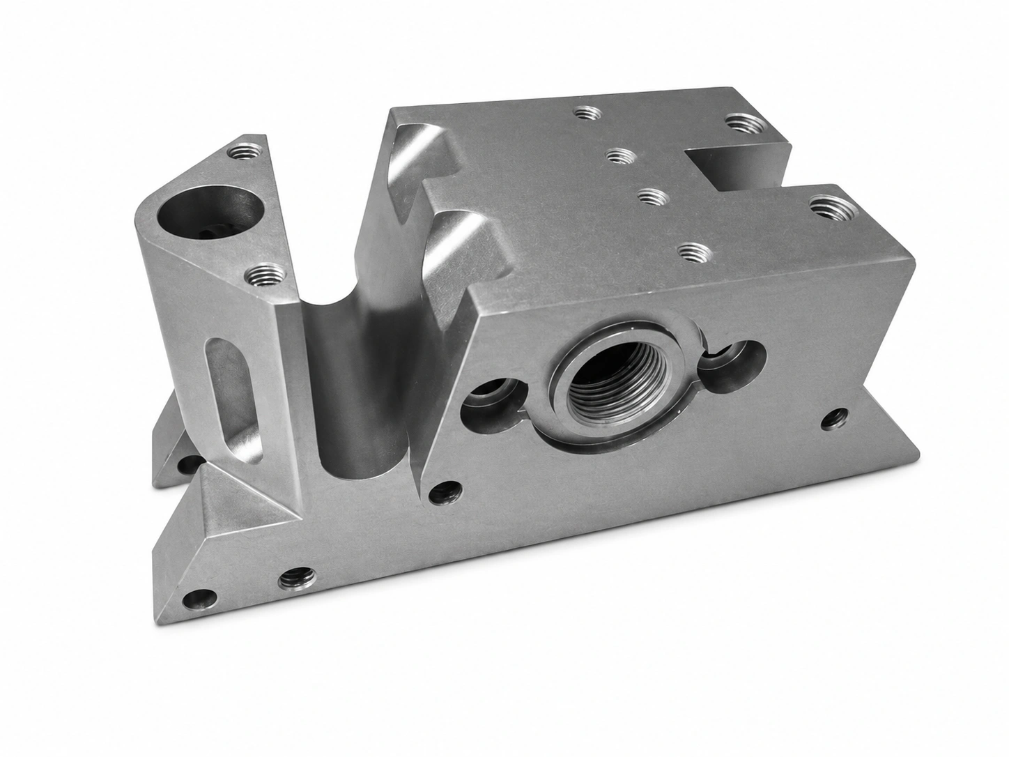 Precision CNC-machined titanium manifold housing with threaded ports, mounting holes, and complex milled features on a white background.